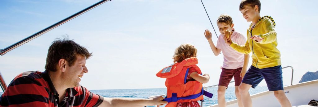 Family captured sailing and having fun aboard a catamaran 