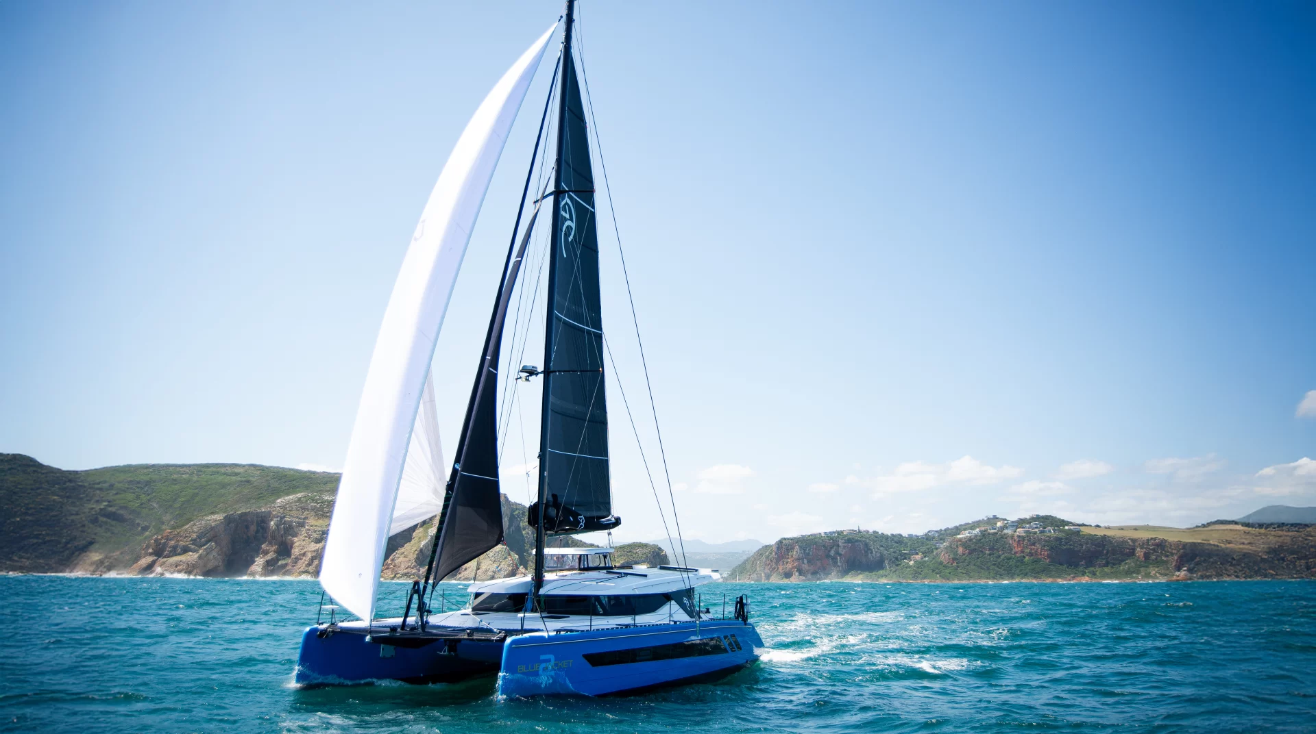Modern Knysna Yacht Company catamaran sailing in open water, highlighting innovation and craftsmanship in Knysna Yacht Co. products.