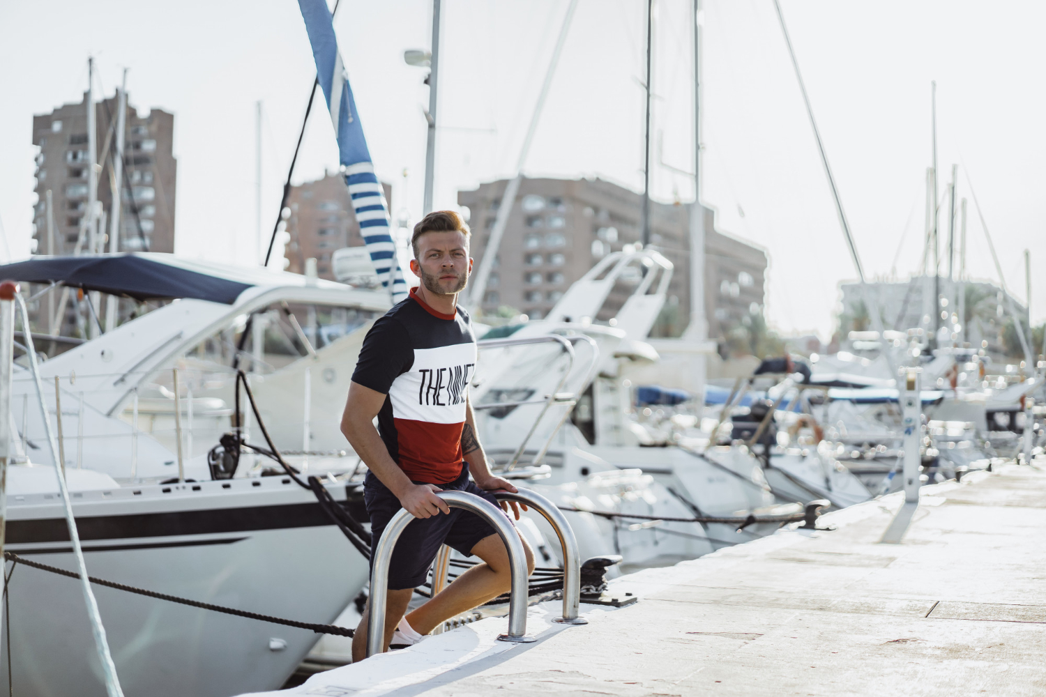 View Of A Young Man Amongst Luxury Yachts